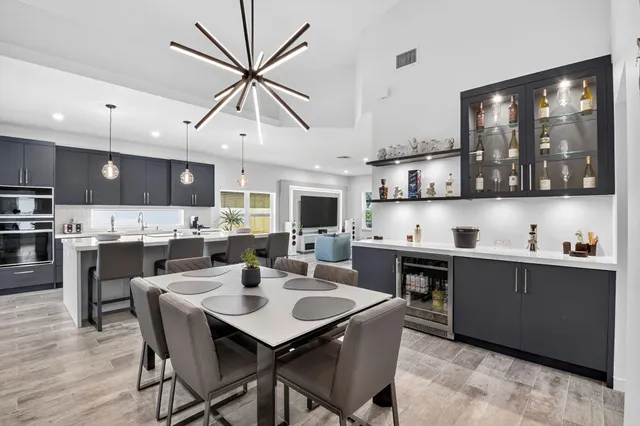 a kitchen with kitchen island a counter top space a sink stainless steel appliances and cabinets