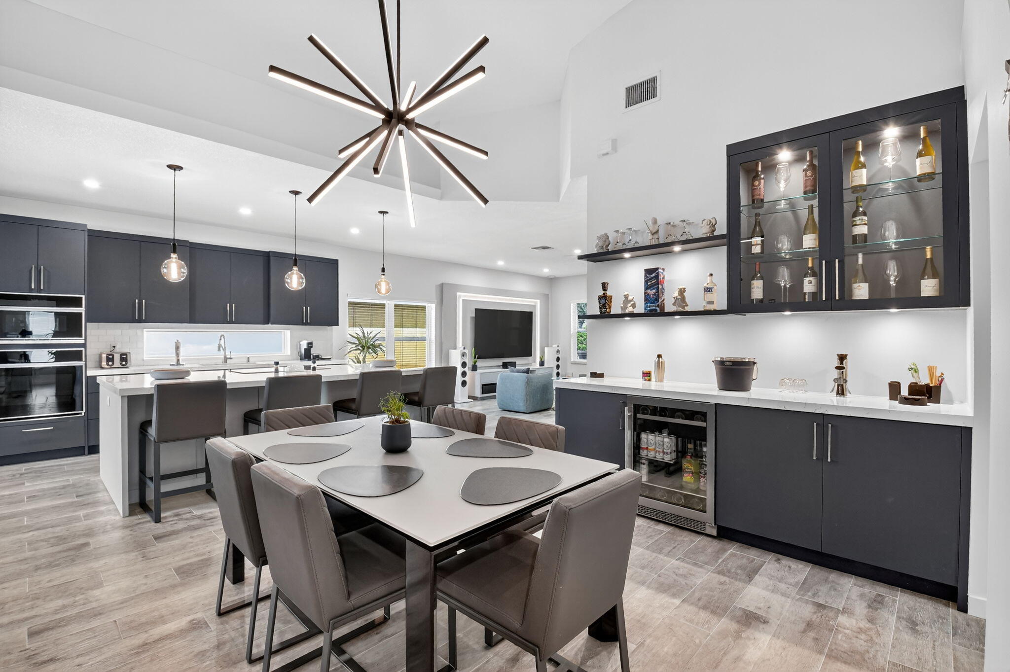 494 Enfield Court Delray Beach, FL 33444 - Photo 16 of 78 a kitchen with stainless steel appliances kitchen island granite countertop a sink a stove a dining table and chairs