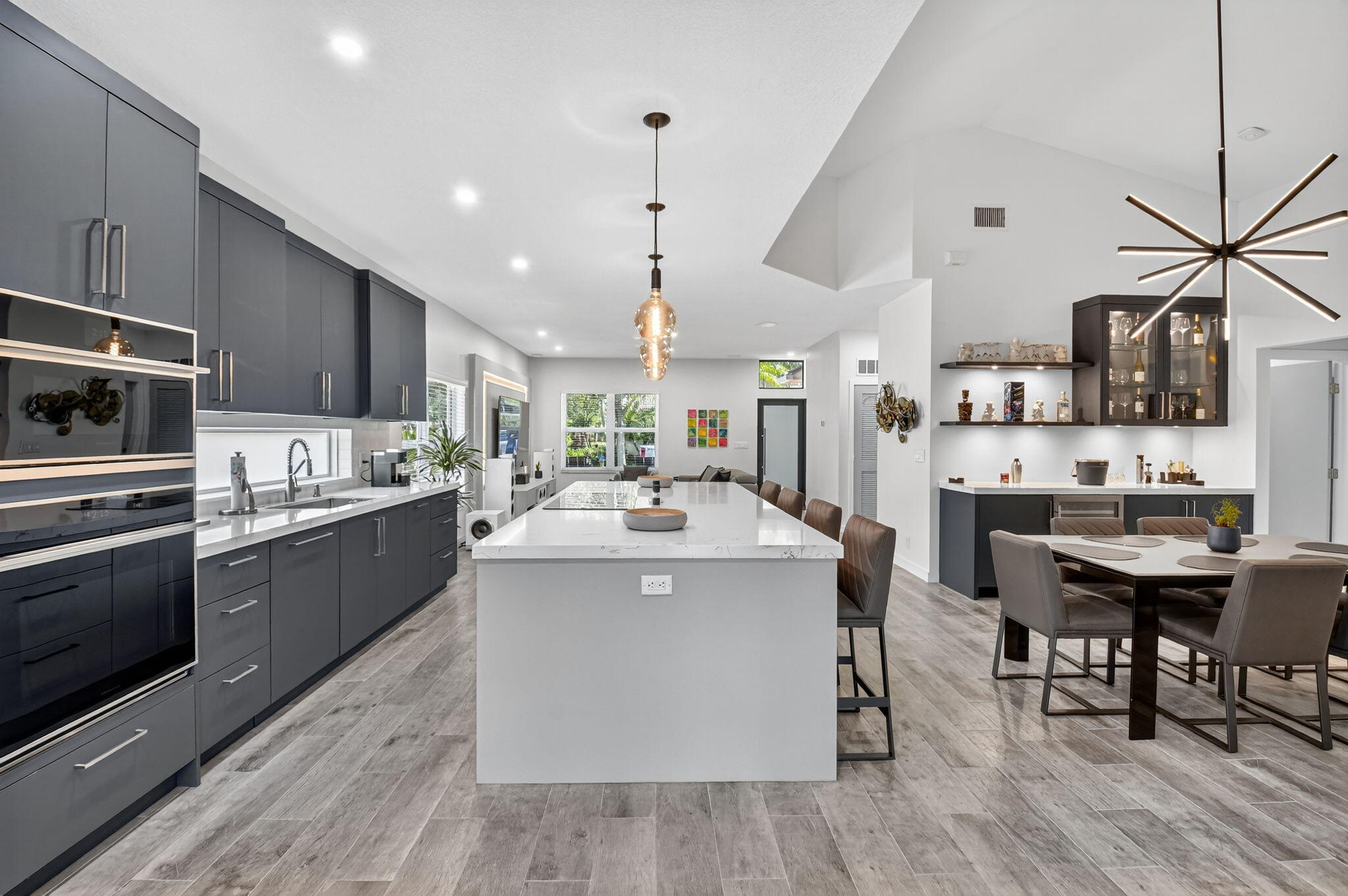 494 Enfield Court Delray Beach, FL 33444 - Photo 20 of 78 a kitchen with stainless steel appliances kitchen island a large island in the center