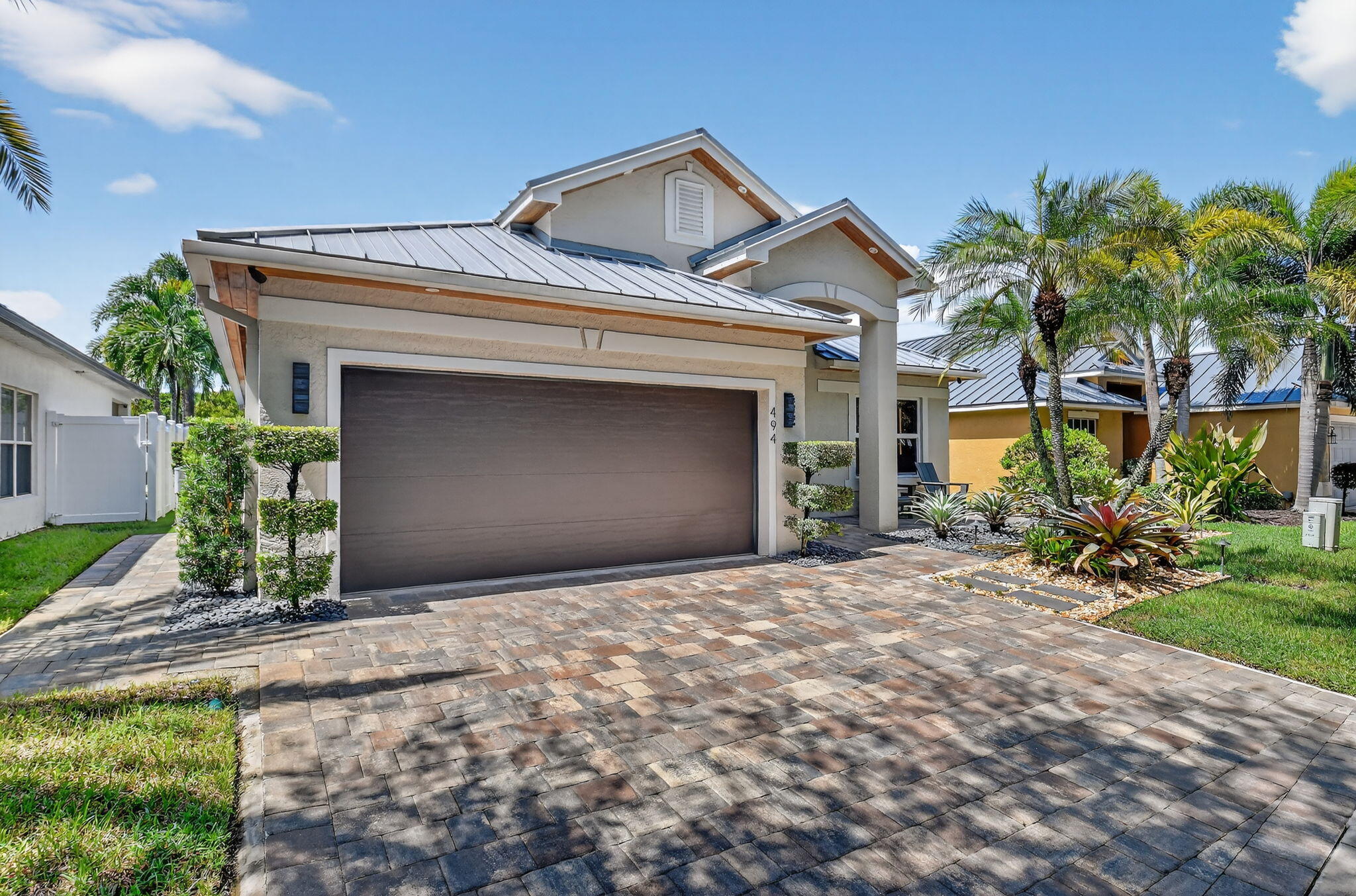 494 Enfield Court Delray Beach, FL 33444 - Photo 2 of 78 a front view of a house with a yard and garage