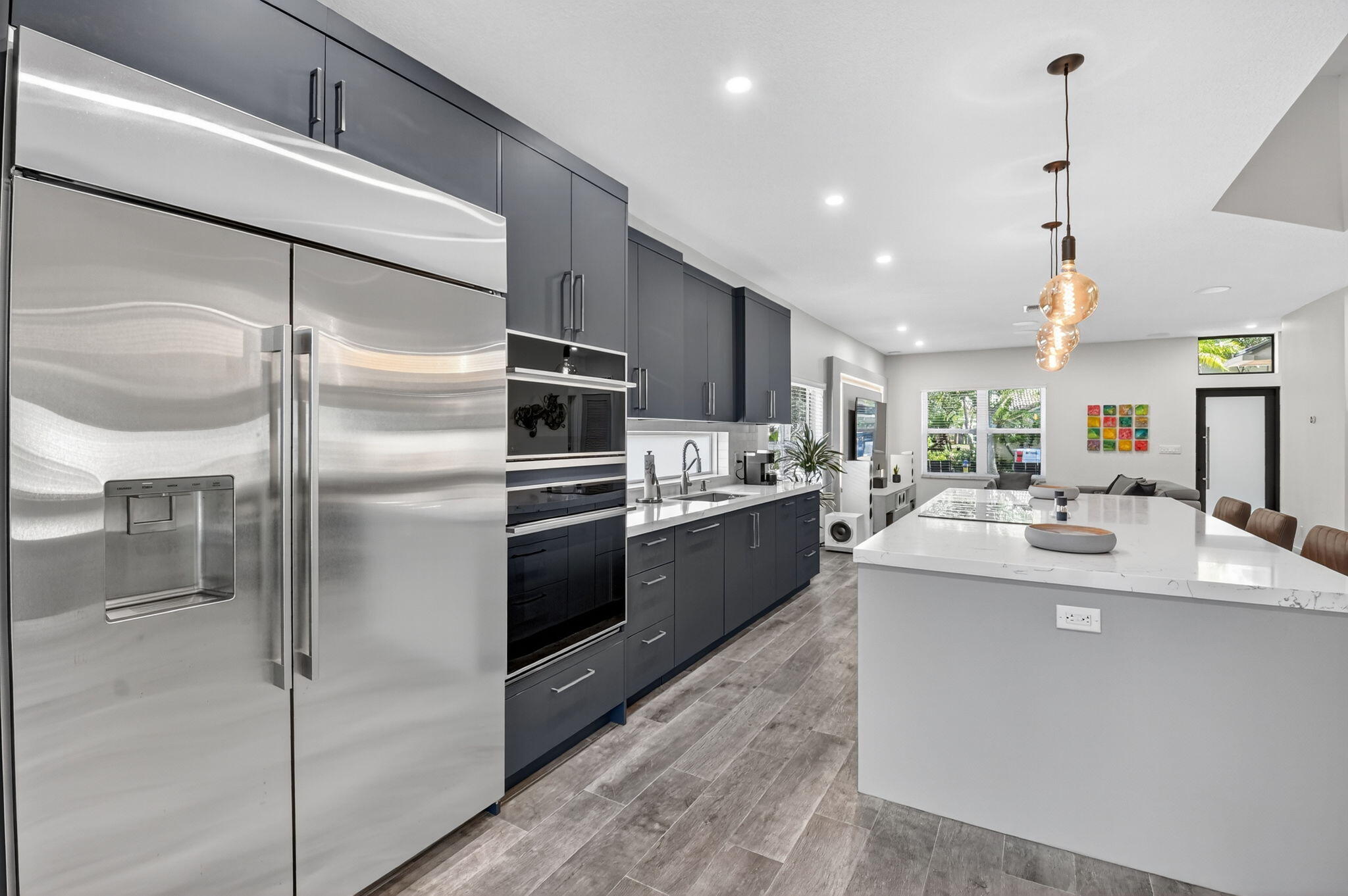494 Enfield Court Delray Beach, FL 33444 - Photo 21 of 78 a kitchen with kitchen island a counter top space a sink stainless steel appliances and cabinets