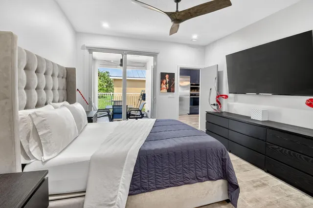 a view of a backyard with swimming pool and sitting area