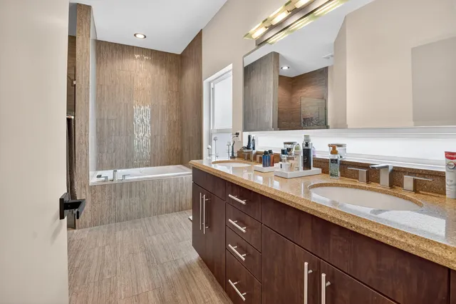 an aerial view of residential houses with outdoor space and trees