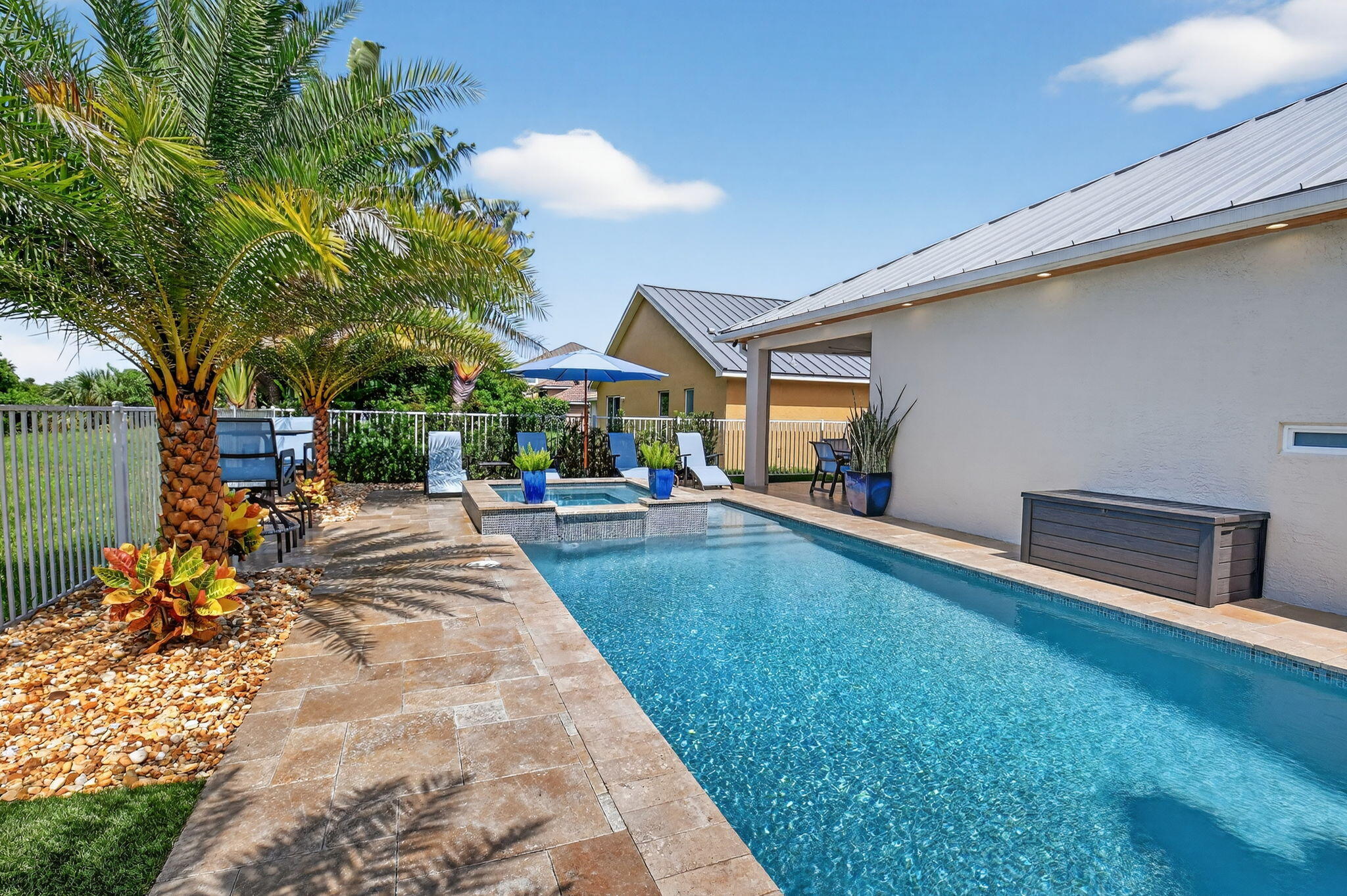 494 Enfield Court Delray Beach, FL 33444 - Photo 45 of 78 a view of a patio with table and chairs under an umbrella