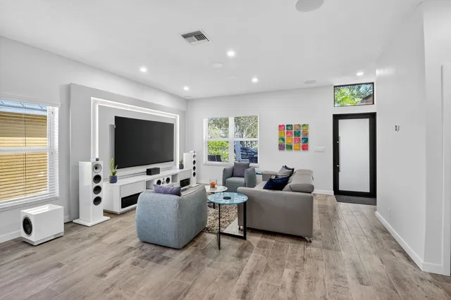 a large kitchen with stainless steel appliances kitchen island a large counter tops and a view of living room