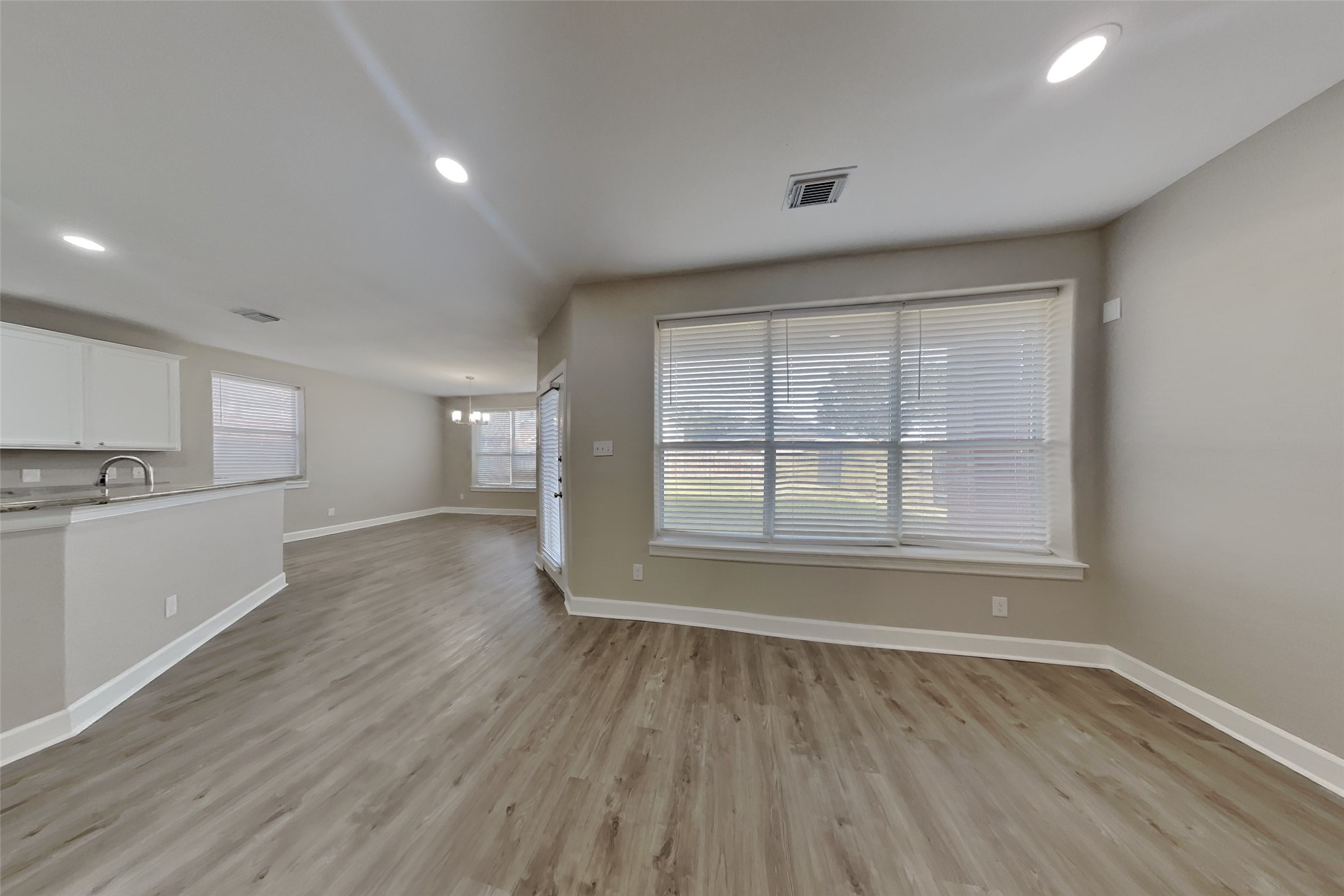 4718 Wild Bluebonnet Way Houston, TX 77084 - Photo 3 of 20 an empty room with wooden floor and windows