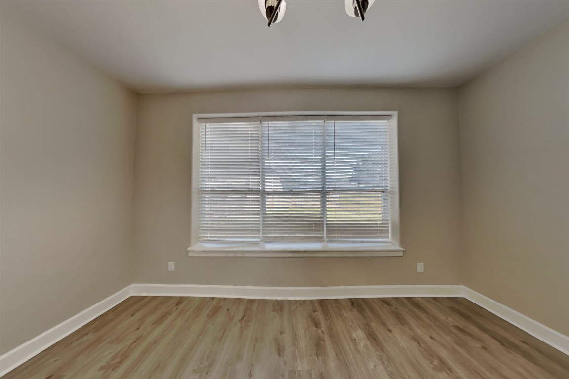 4718 Wild Bluebonnet Way Houston, TX 77084 - Photo 5 of 20 a view of an empty room with wooden floor and a window