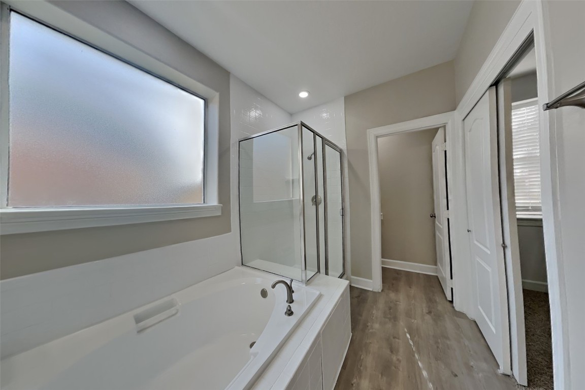 4718 Wild Bluebonnet Way Houston, TX 77084 - Photo 9 of 20 a bathroom with a bathtub and a shower