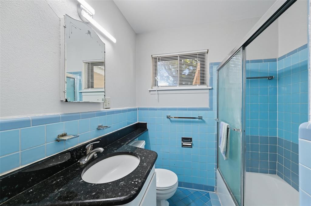 3512 Park Ridge Boulevard Fort Worth, TX 76109 - Photo 10 of 16 a bathroom with a sink toilet a mirror and shower