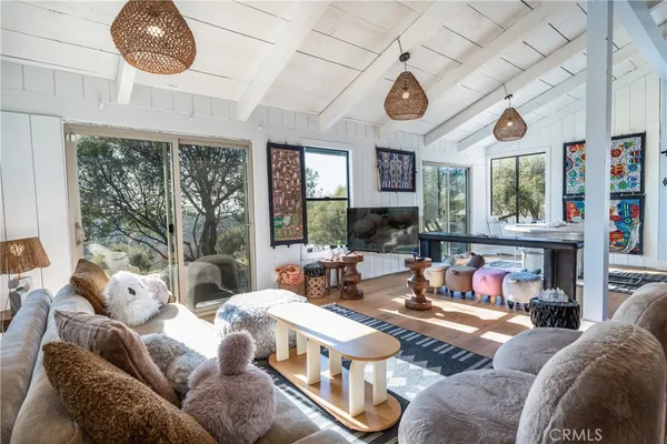 a living room with furniture a fireplace and a large window