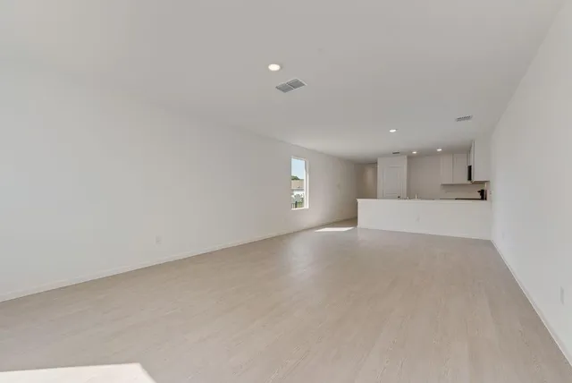 a view of kitchen with stainless steel appliances granite countertop refrigerator sink and cabinets