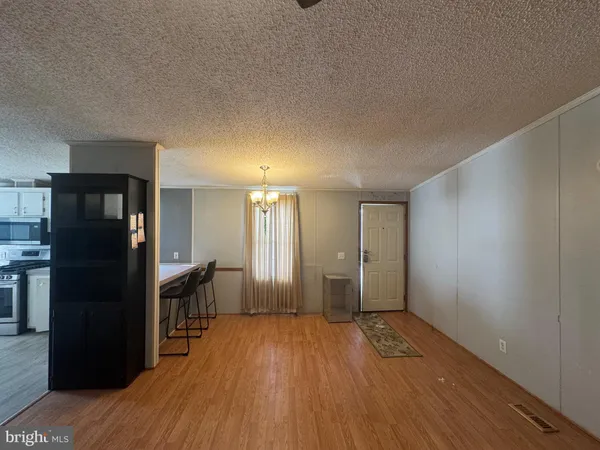 a view of a kitchen from the hallway