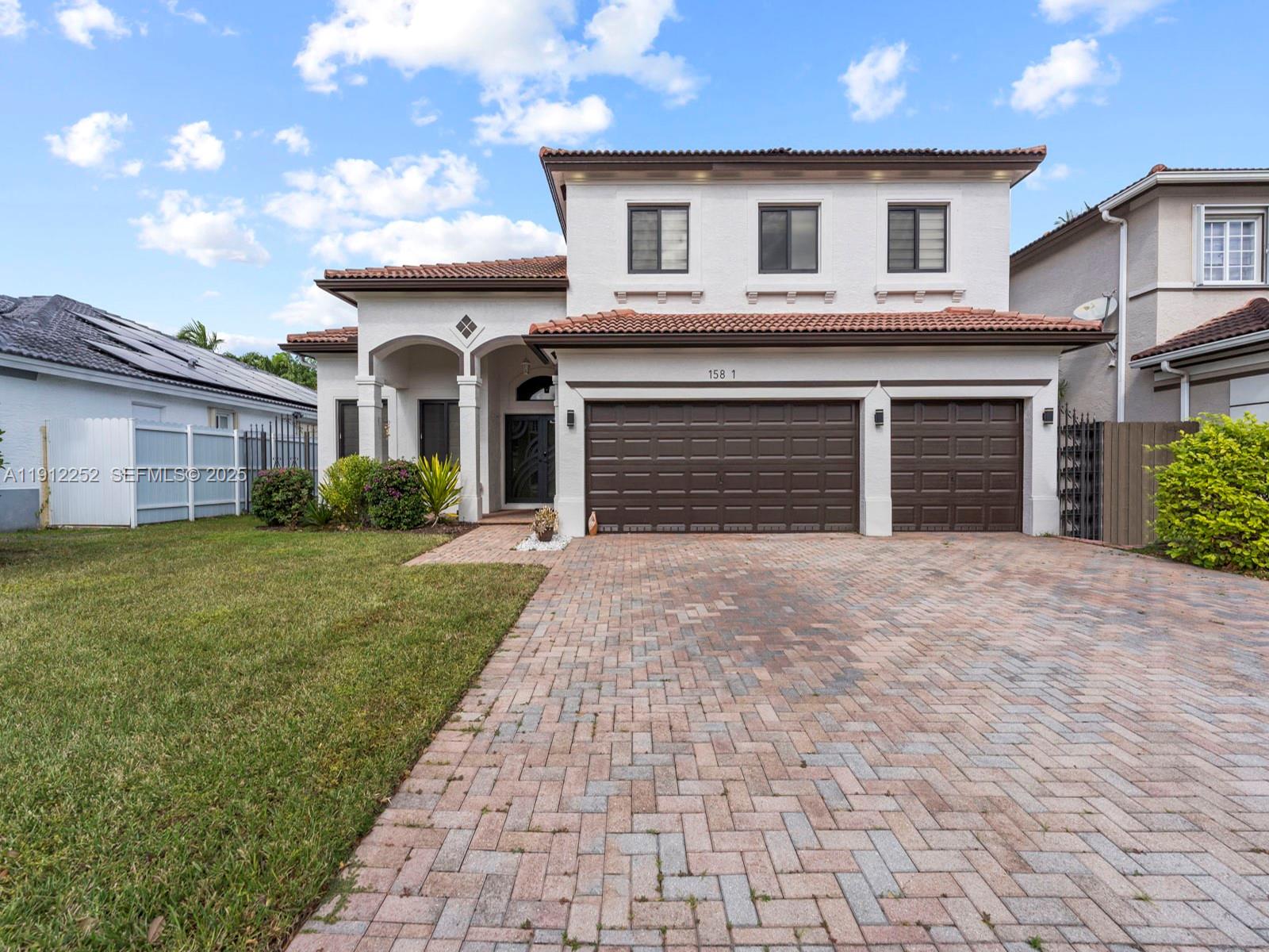 15871 Southwest 141st Street Miami, FL 33196 - Photo 1 of 41 a front view of a house with a yard and garage