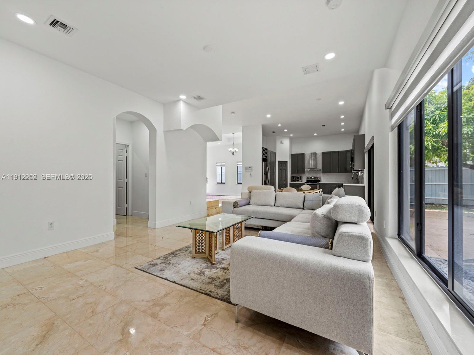15871 Southwest 141st Street Miami, FL 33196 - Photo 13 of 41 a living room with furniture and a large window