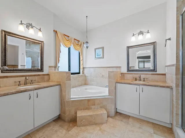 a bathroom with a shower sink and mirror