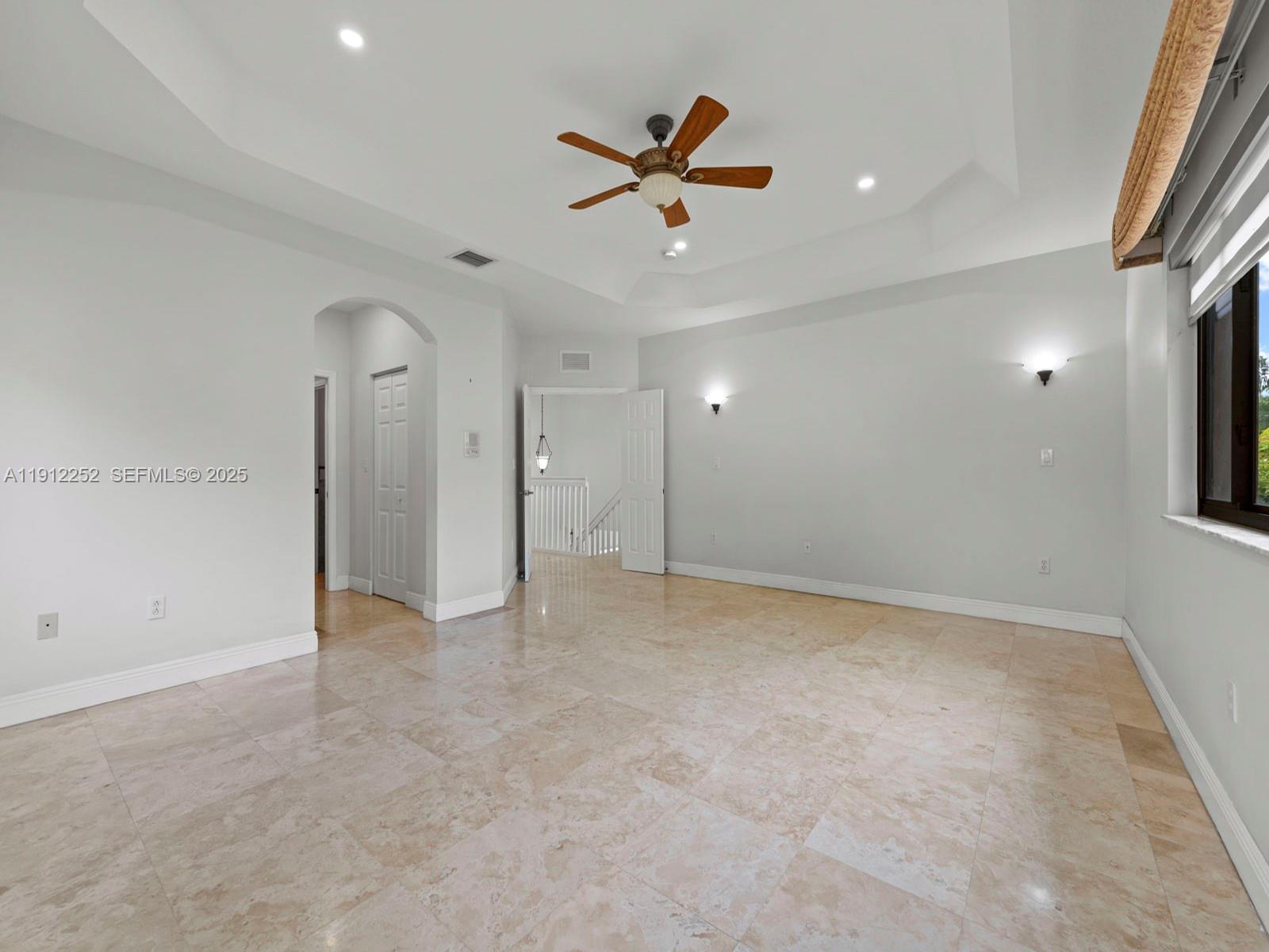 15871 Southwest 141st Street Miami, FL 33196 - Photo 23 of 41 an empty room with ceiling fan and window