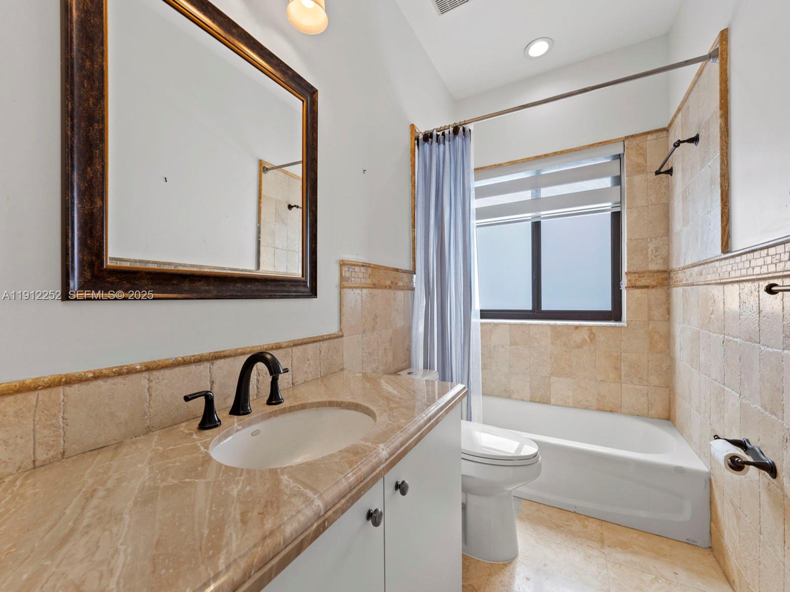 15871 Southwest 141st Street Miami, FL 33196 - Photo 28 of 41 a bathroom with a granite countertop sink toilet and shower