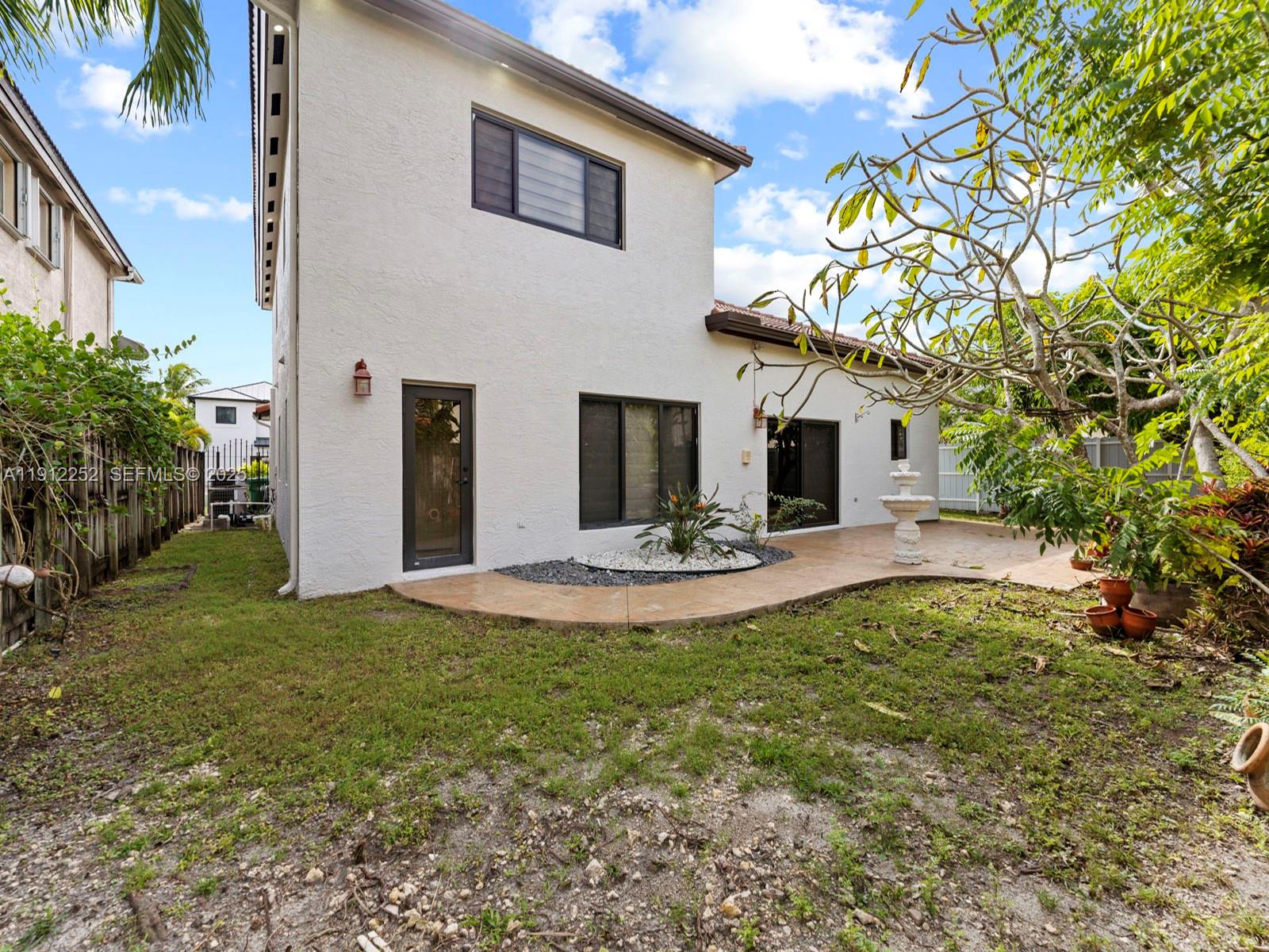 15871 Southwest 141st Street Miami, FL 33196 - Photo 32 of 41 a view of a house with backyard and sitting area