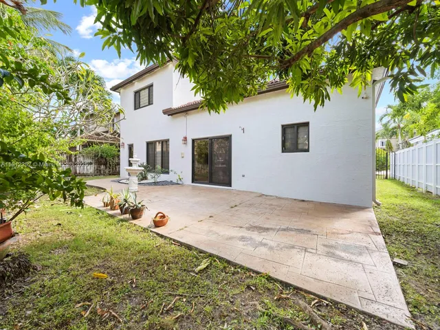 an aerial view of a house with garden space and sitting area