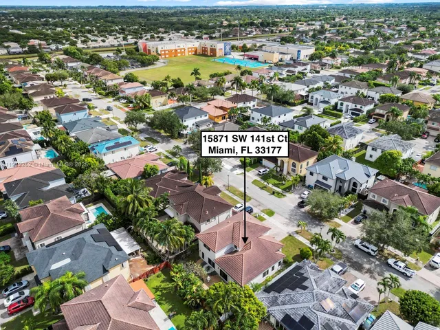 an aerial view of residential houses with outdoor space