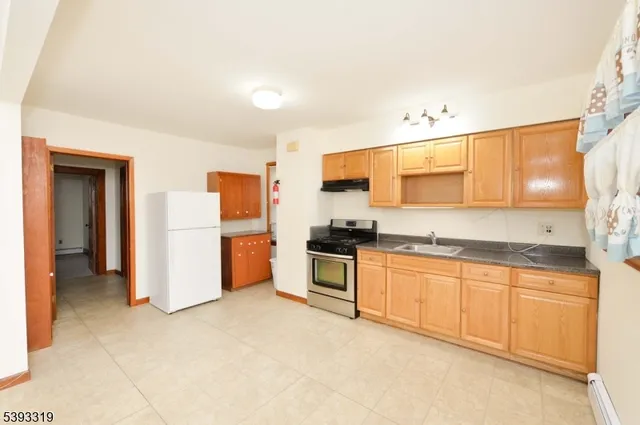 a kitchen with granite countertop a sink stainless steel appliances and cabinets