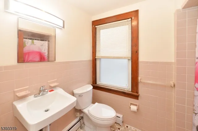 a white toilet sitting next to a bathroom sink