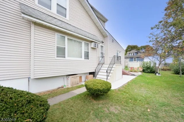 a view of a house with backyard and a tree