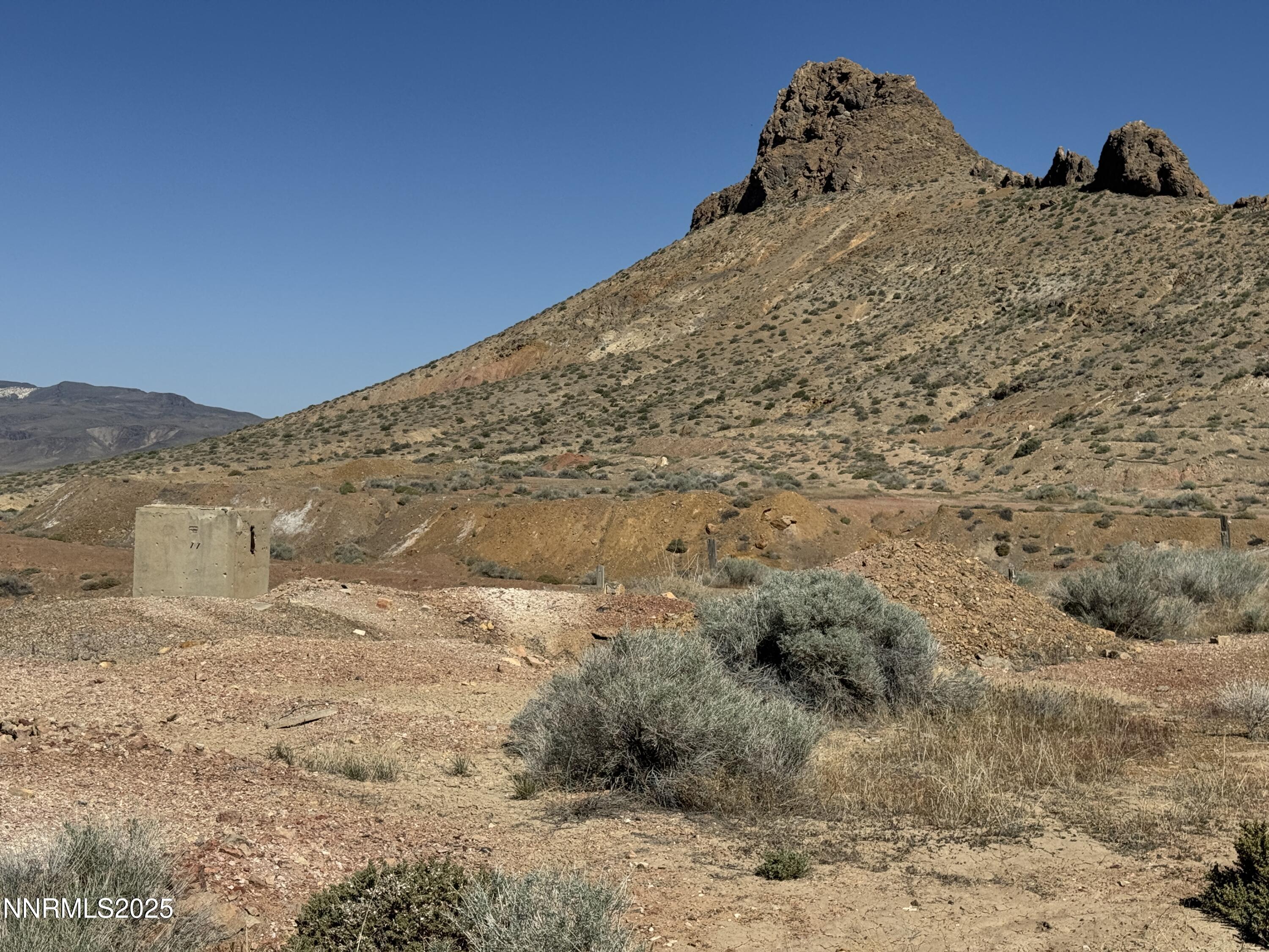 1508012 Coal Canyon Road Lovelock, NV 89419 - Photo 6 of 40 a view of a dry field with mountains in the background