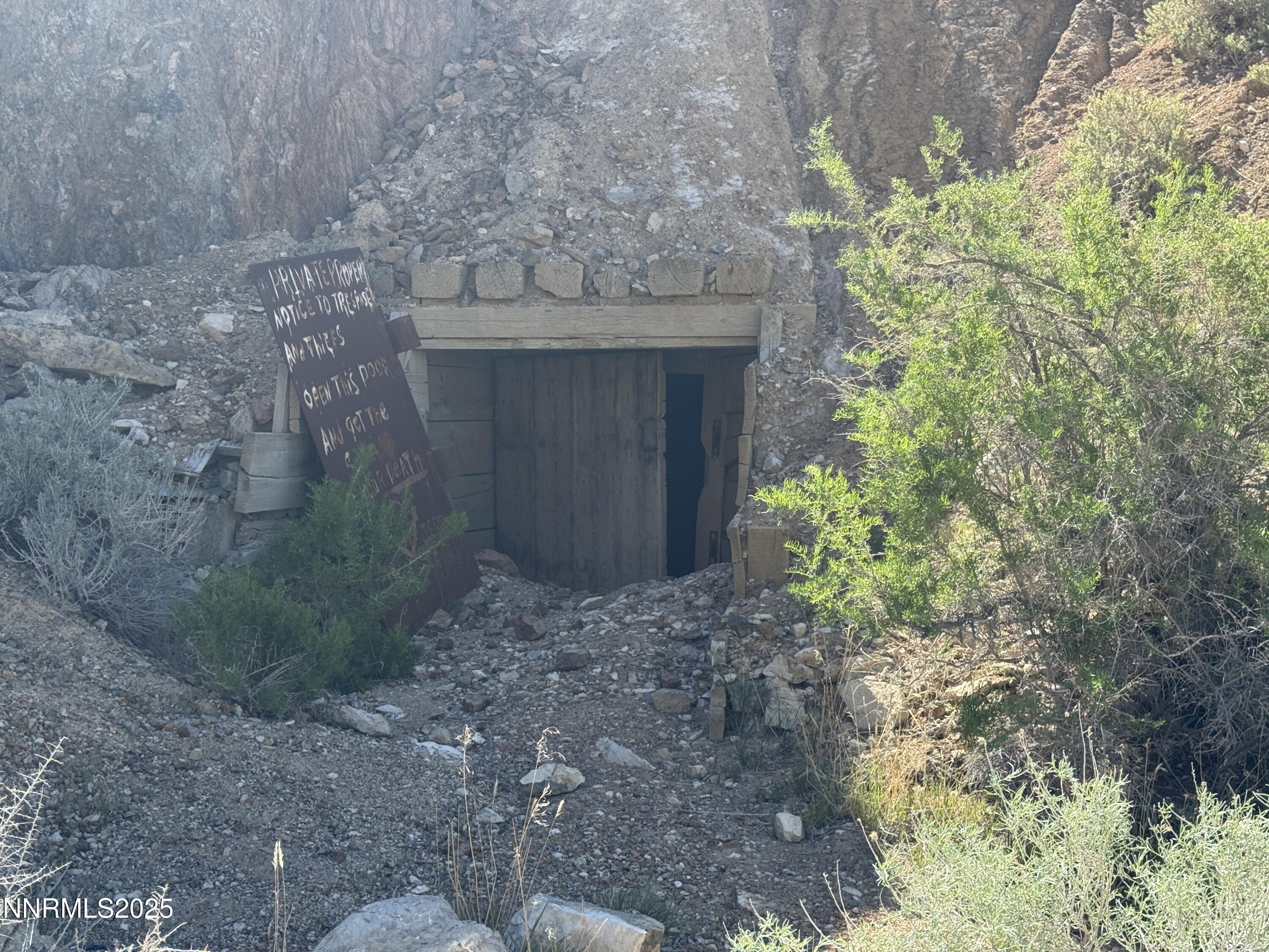 1508012 Coal Canyon Road Lovelock, NV 89419 - Photo 8 of 40 a stone house with a yard and plants