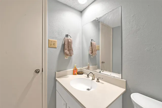 a bathroom with a sink toilet and vanity