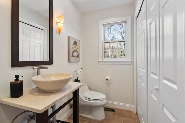 a bathroom with a toilet a sink and a mirror
