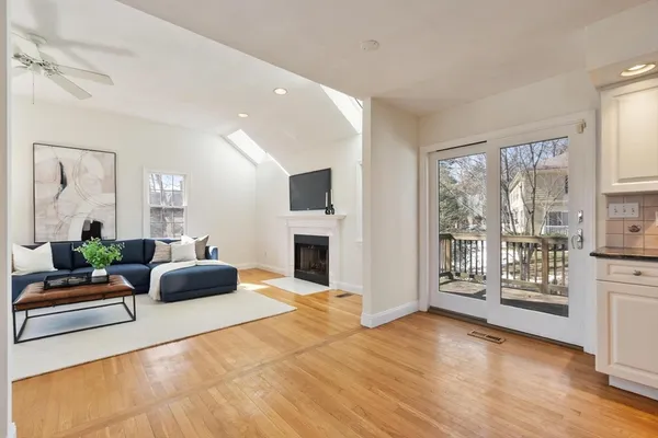 a living room with furniture a fireplace and a floor to ceiling window