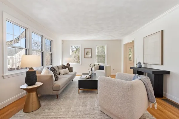 a living room with furniture a table and a large window