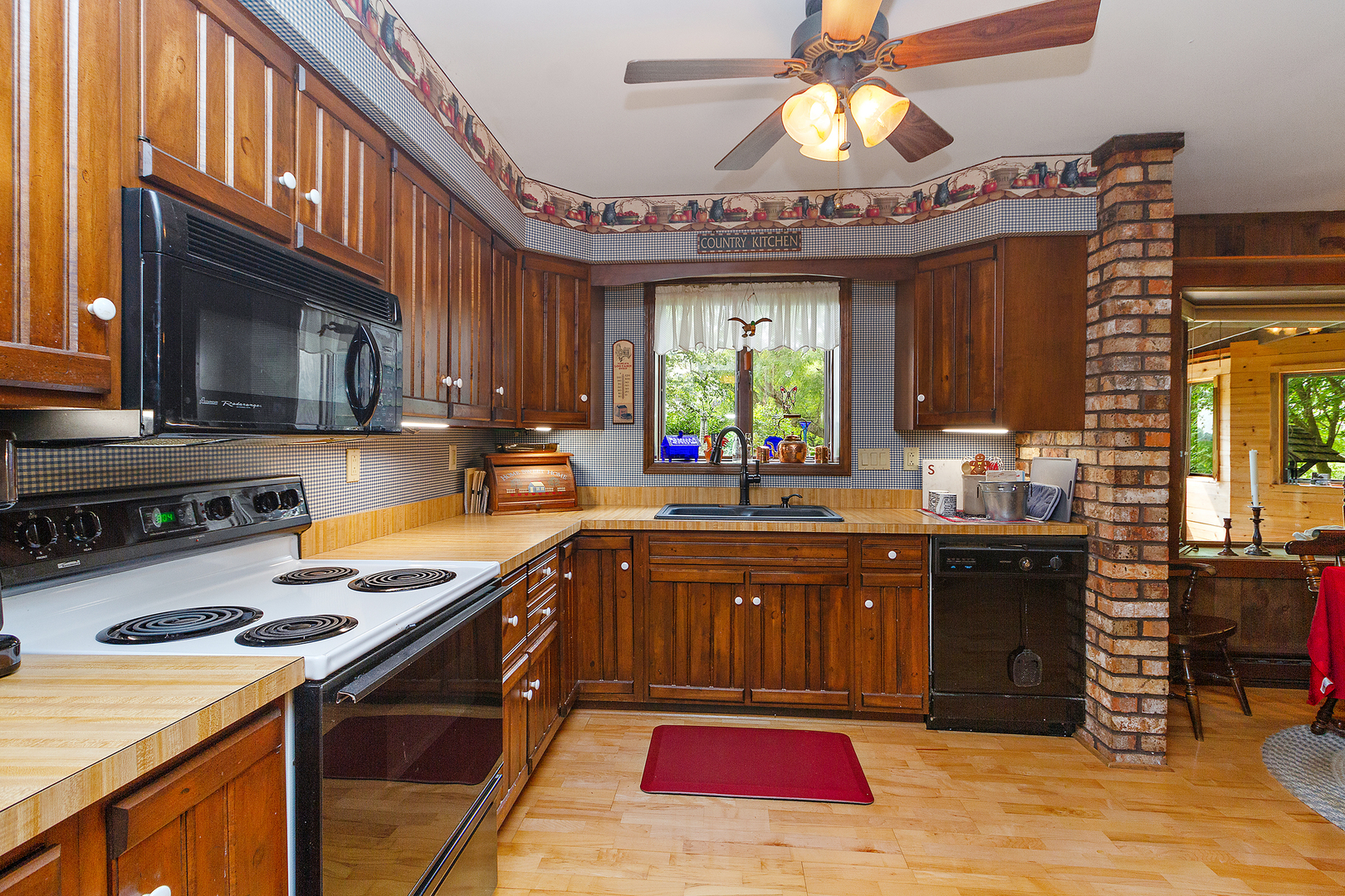 32444 Wilton Road Manhattan, IL 60442 - Photo 11 of 28 a kitchen with a stove a sink and a microwave