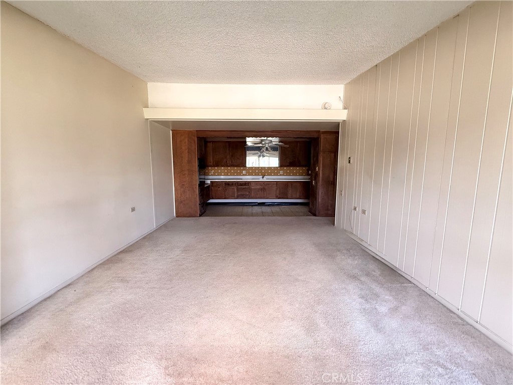 1621 Monterey Road, Unit 19H Seal Beach, CA 90740 - Photo 3 of 10 a view of empty room with a fireplace