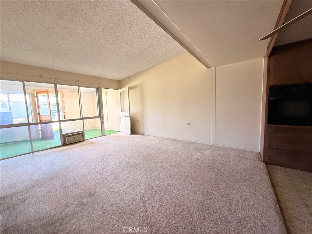 1621 Monterey Road, Unit 19H Seal Beach, CA 90740 - Photo 5 of 10 a view of livingroom with furniture and floor to ceiling window
