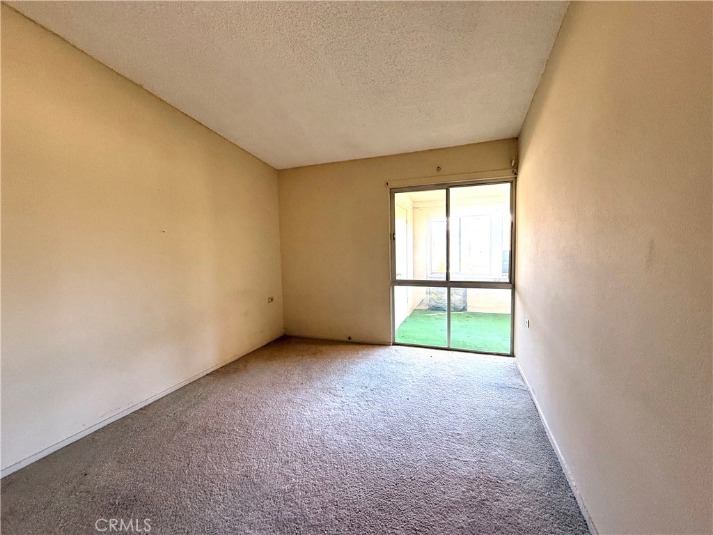 1621 Monterey Road, Unit 19H Seal Beach, CA 90740 - Photo 9 of 10 an empty room with large windows