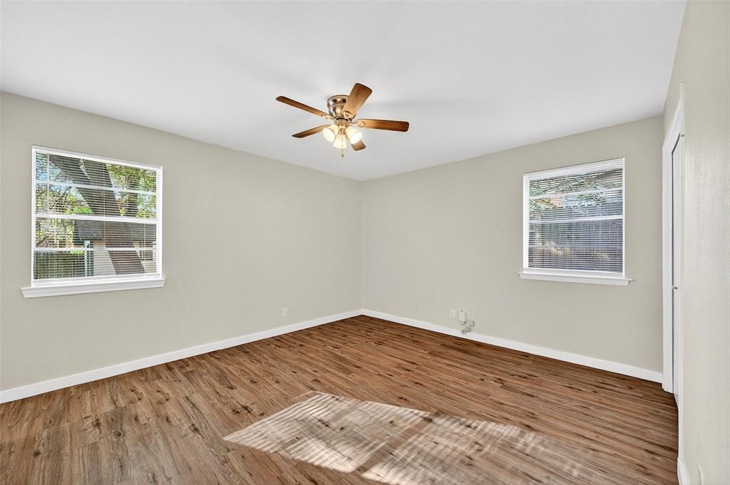 218 Kansas Street Sherman, TX 75090 - Photo 13 of 22 a view of an empty room with a window and wooden floor