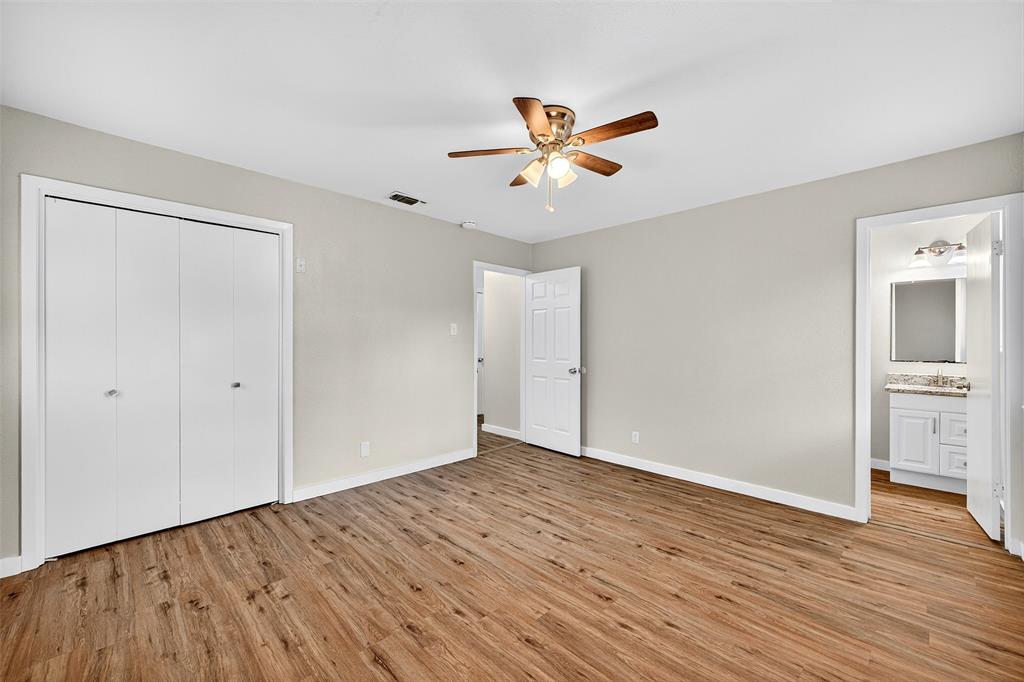 218 Kansas Street Sherman, TX 75090 - Photo 14 of 22 a view of an empty room with a window and wooden floor