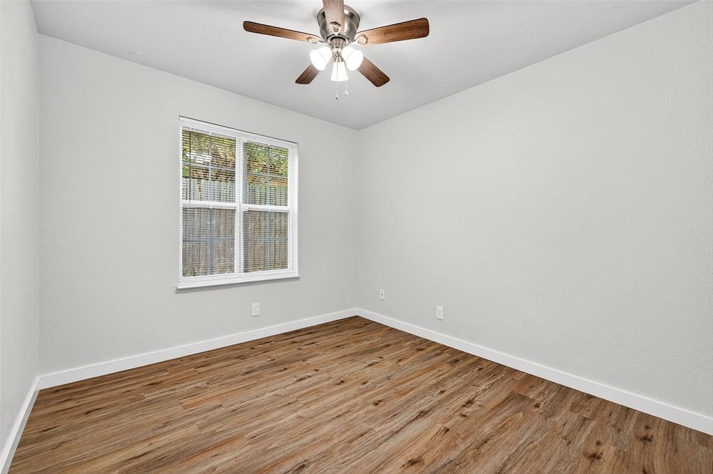 218 Kansas Street Sherman, TX 75090 - Photo 16 of 22 wooden floor in an empty room with a window