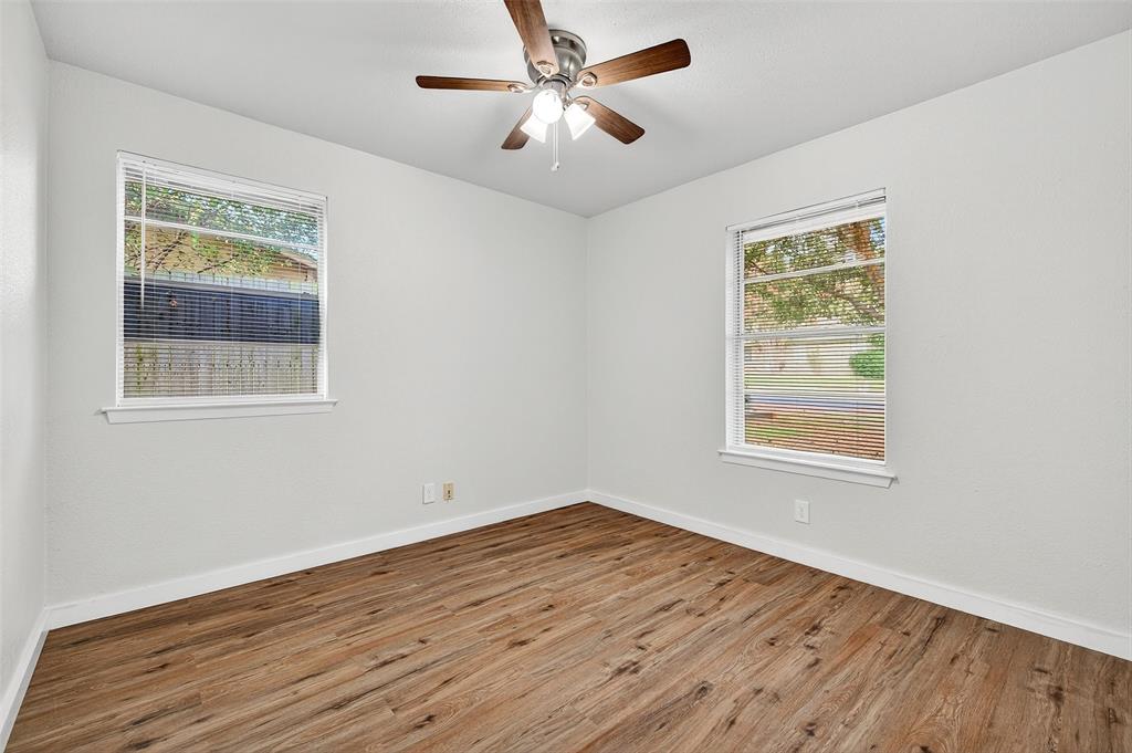 218 Kansas Street Sherman, TX 75090 - Photo 18 of 22 a view of an empty room with wooden floor and a window