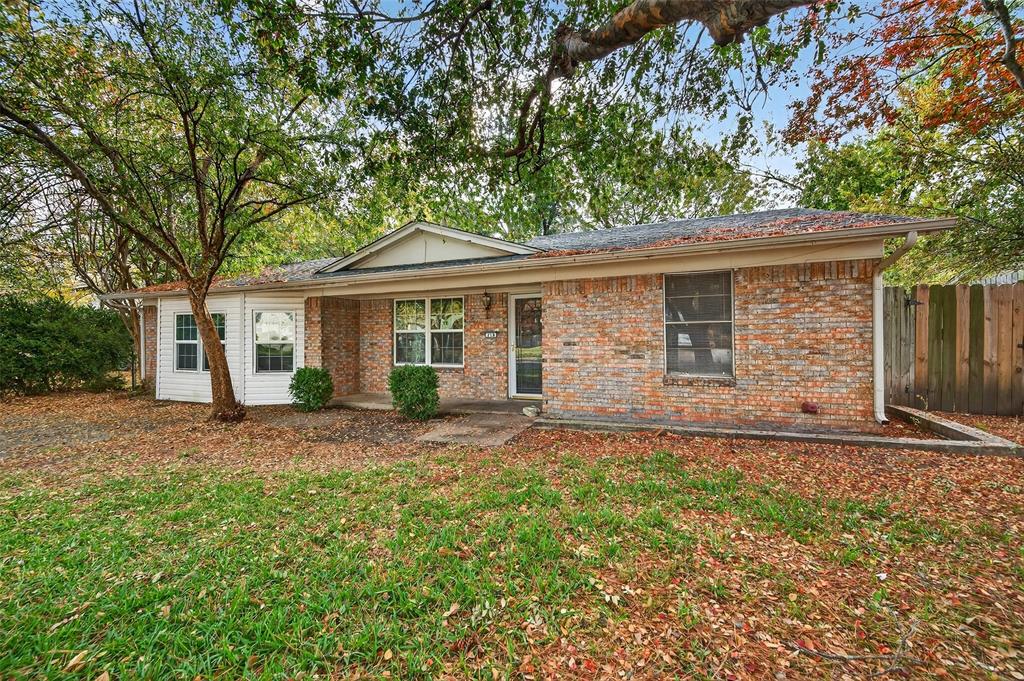 218 Kansas Street Sherman, TX 75090 - Photo 2 of 22 a front view of a house with a garden