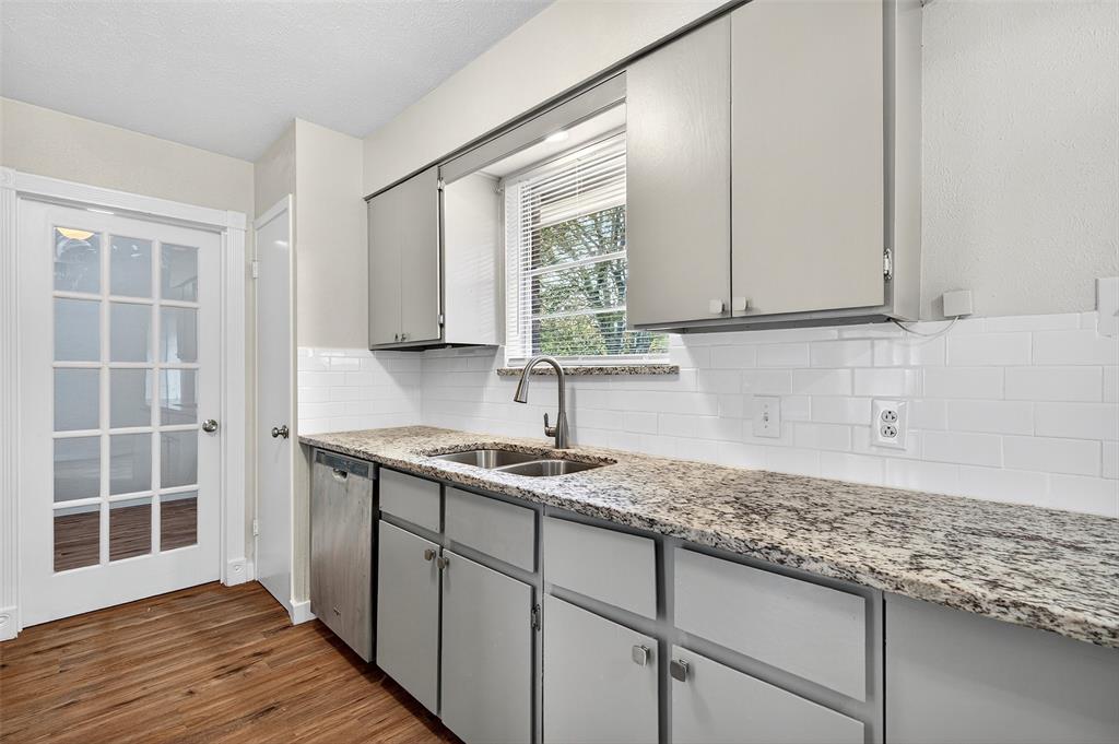 218 Kansas Street Sherman, TX 75090 - Photo 8 of 22 a kitchen with a sink cabinets and window