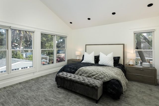 a spacious bedroom with a bed and a large window