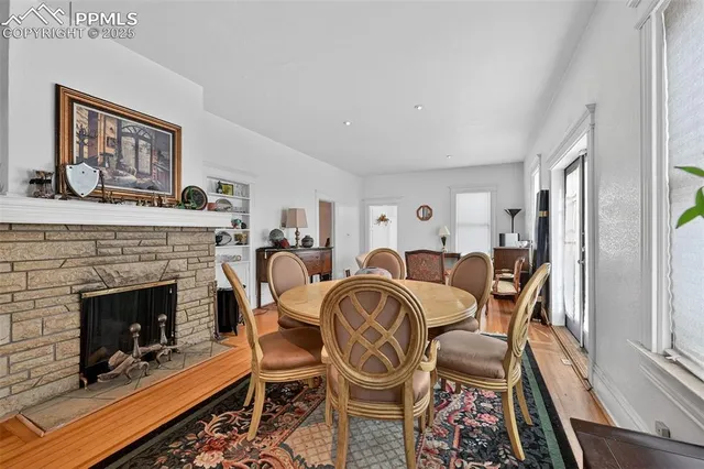 a living room with furniture a fireplace and a window