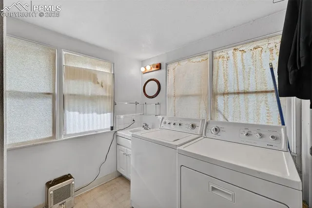 a bedroom with two beds and a chandelier