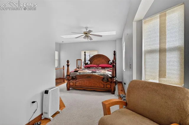 a bedroom with furniture and a flat screen tv