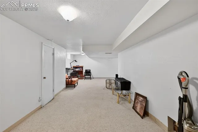 a view of a bedroom with workspace and staircase