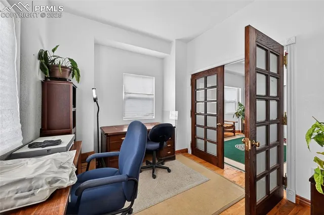 a view of a workspace with furniture and a window