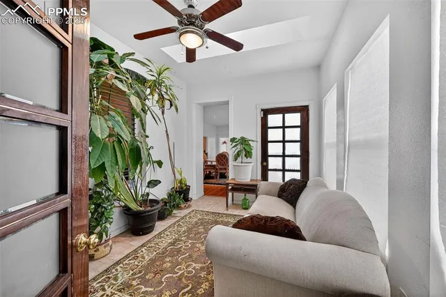 a living room with furniture and a potted plant